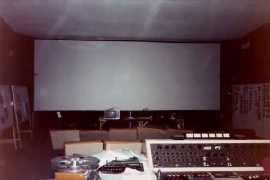 The Owensby Screening room. A 65MM film reel on it's side in FG.